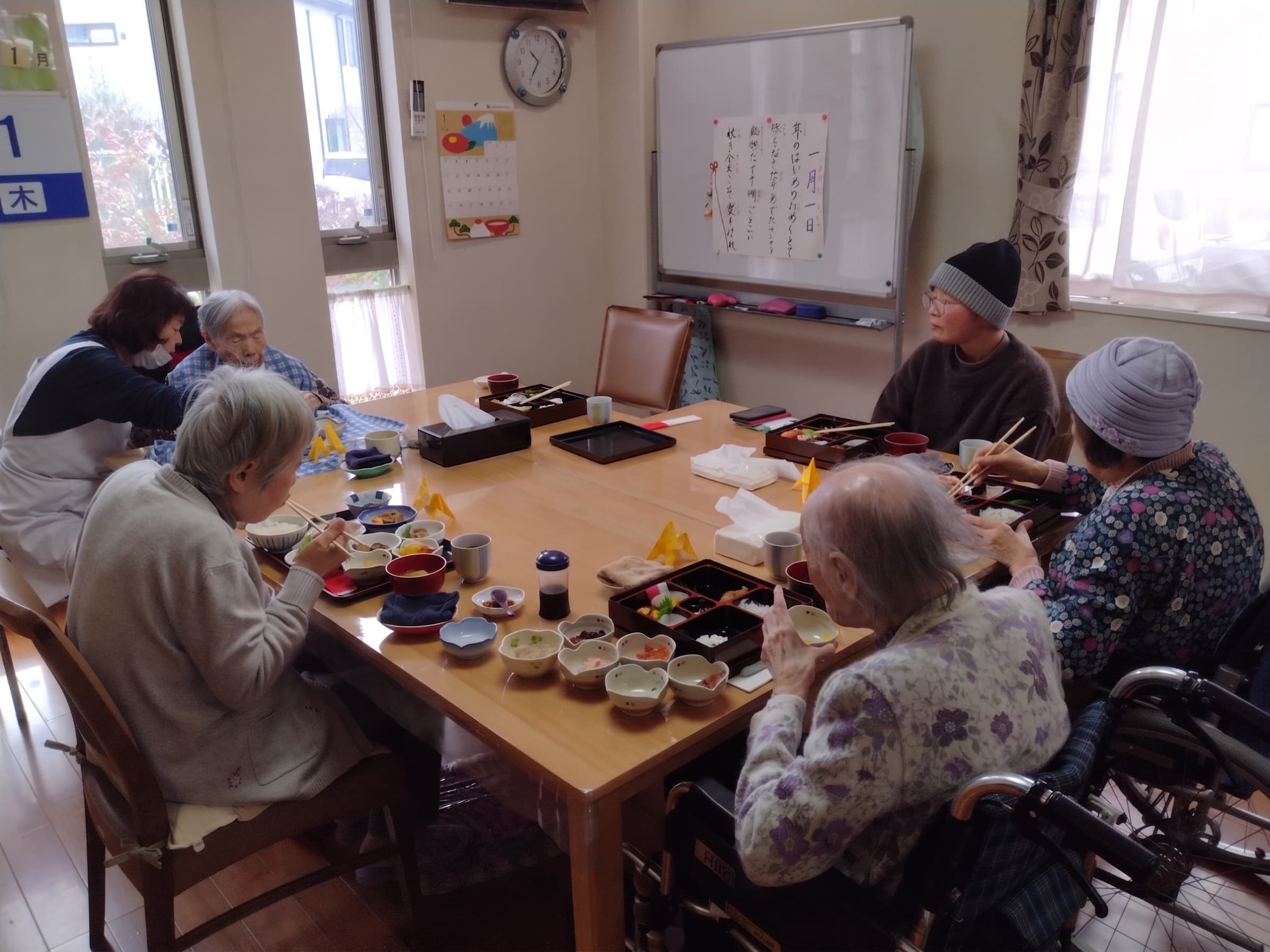 シズル感のあるスライドショー:湯気が立つ温かな手作りお膳、広い庭で入居者とセラピー犬が笑い合っている様子、スタッフが入居者の手を握り穏やかに談笑するシーン